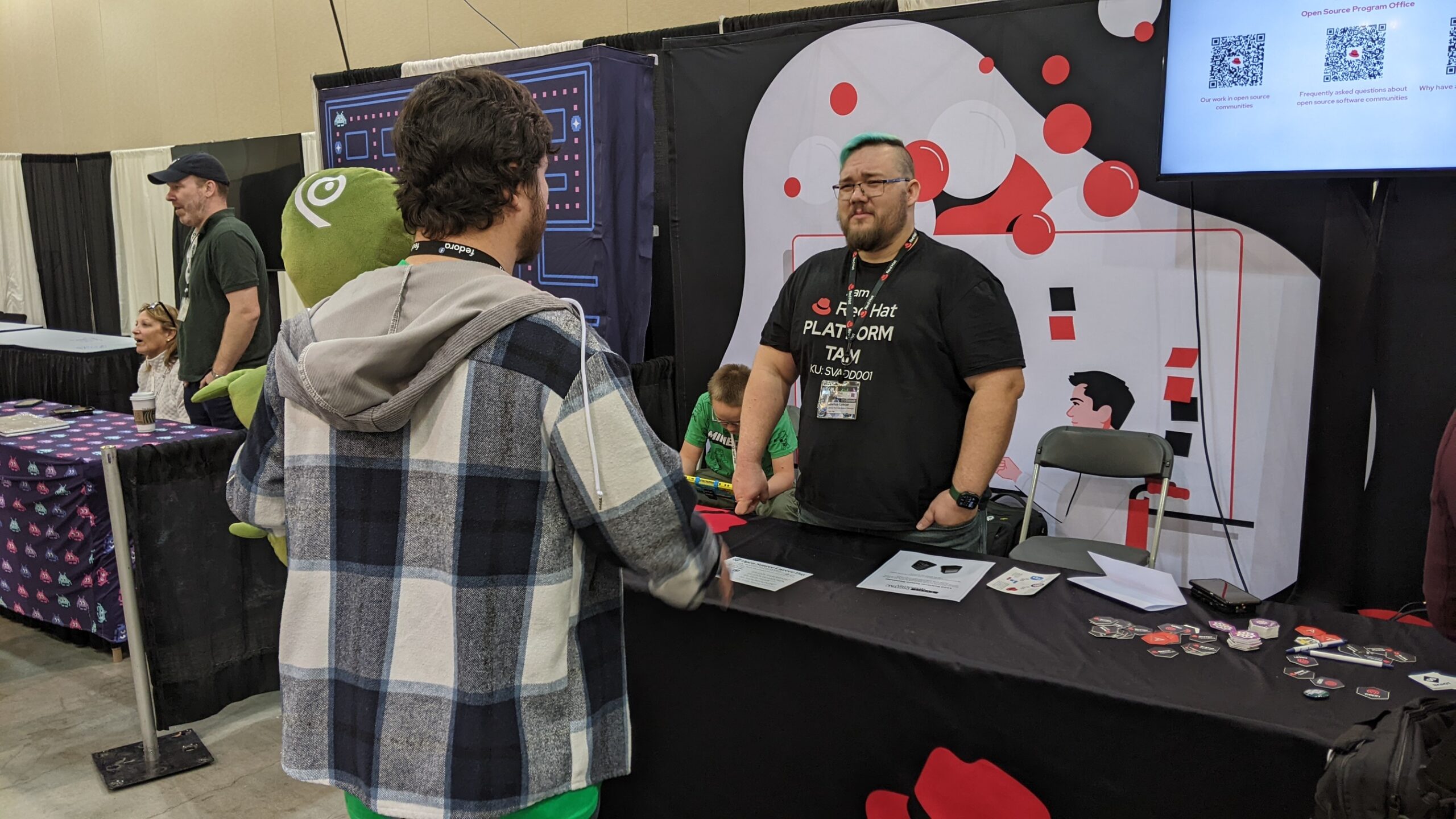 Scott Williams chats with Joshua Loscar at the Red Hat Booth