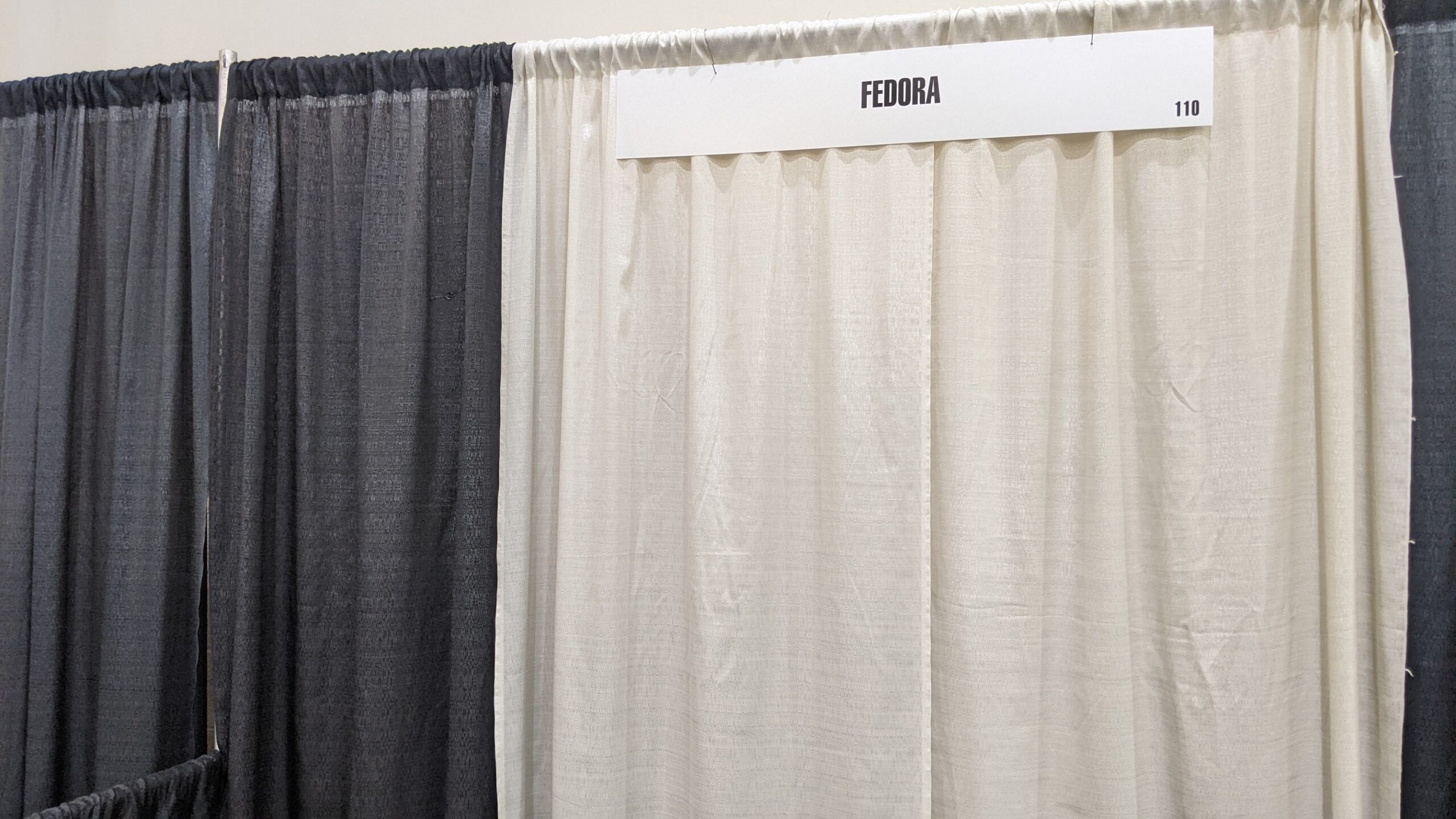 picture of the back of the Fedora booth-a sheet wall